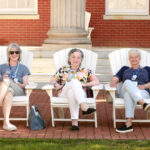 1974 alumnae sit for a spell on the Adirondack chairs on Ball Circle. Ball Hall served as housing for dozens of alumni during Reunion Weekend. Photo by Karen Pearlman.