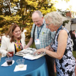 1979 graduates peruse a Battlefield yearbook during the welcome reception at Brompton on Friday. Photo by Karen Pearlman.