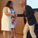 Simran Kaur-Colbert '11 shakes President Paino's hand after receiving the Outstanding Young Alumni Award. Photo by Karen Pearlman.