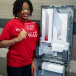 Each Aunt Flow machine can hold 50 tampons and 50 pads (which read 'Changing the world one cycle at a time' on the packaging). Machines also feature Braille for visually impaired students and are easy to reach for those who are physically impaired. Photo by Sam Cahill.