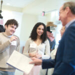 Seniors Oscar León and Mina Sollars chat about costumes from UMW Theatre productions with Mark Ingrao '81 and Lisa Taylor '85 during the Student Showcase. Photo by Karen Pearlman Photography.