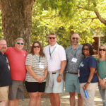 1994 graduates, who celebrated their 30th reunion, pose for a photo under the shade of trees along Campus Walk. Photo by Karen Pearlman.