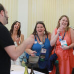 Class of 2014 graduates, including Danielle DeSimone (right) and Shelby Orlando (center), enjoy the Virginia wine, beer, and cider tasting at the Jepson Alumni Executive Center on Saturday. Photo by Karen Pearlman.