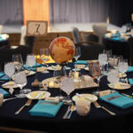 With a study abroad theme, tables were decorated with globes, suitcases, and postcards from far-flung locales across the globe. Photo by Karen Pearlman.
