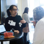 Junior Maha Momtaz, a studio art major at Mary Washington, shares her artwork with a donor at the Student Showcase. Maha is the recipient of the Lettie Pate Whitehead and the Nina G. Bushnell scholarships. Photo by Karen Pearlman.
