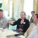 Melissa Schmidt Estevez '00 asks a question while fellow Alumni Board member Sean Lynch '95 (left) and Young Alumni Council members Michael Gilchrist '20 (right) and Theo Zotos '19 (far right) look on. Photo by Karen Pearlman.
