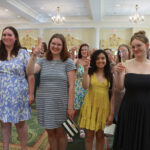 2024 graduates raise a glass of champagne as President Paino makes his toast. Photo by Karen Pearlman.