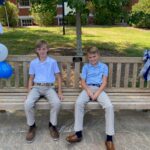 Coby’s sons, Boice and Cole, sitting on their dad’s bench after the dedication ceremony last fall. Photo courtesy of John Anstey.