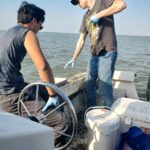 Assistant Professor of Earth and Environmental Science Tyler Frankel (left) and Joseph Gasink '26 collect samples of trace metals near a former coal-tar creosote plant in Delaware. Photo courtesy of Joseph Gasink.