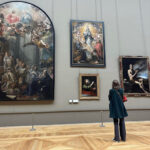 Hayley takes a moment to ponder paintings at the Louvre in Paris. Photo courtesy of Hayley Madden.