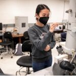 UMW student Boramy Meng works with the transmission electron microscope Irene Piscopo Rodgers gifted to Mary Washington in 2004. Having made a name for herself in the field of electron microscopy, Irene trained UMW faculty and students to use the instrument. Photo by Tom Rothenberg.