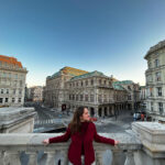 Sofia studied abroad in Vienna, Austria, in spring 2023. Here, she poses for a photo on the balcony of the Albertina Museum, overlooking the Wiener Staatsoper (Vienna State Opera). Photo courtesy of Sofia Taylor.