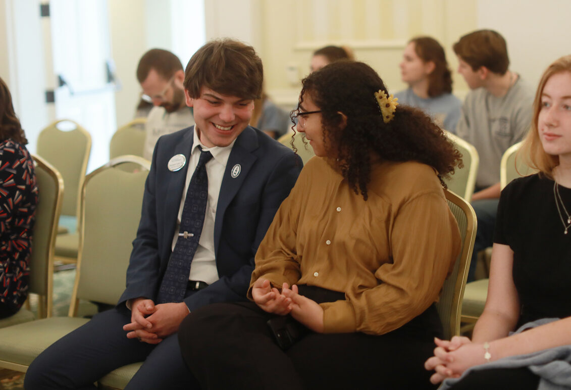 Shadwick Yoder '25, vice president of the Student Government Association, and Amira Said '26, UMW Senate vice president, chat in between presentations, while Callie Harkins '26 (right), editor of The Weekly Ringer student newspaper, looks on. Photo by Karen Pearlman.