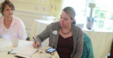 Alumni Board member Colette Strawn Johnson '97 (right) takes notes during the Fund for Mary Washington Impact Grant presentations while Alumni Board member Jennifer Boyd Ross '79 looks on. Photo by Karen Pearlman.