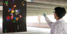 Alexander Rosas, a senior at Stafford High School, shows off his strategy of using heavily painted cotton balls on the right side of the canvas and reused cotton balls on the left side to demonstrate that the amount of energy put into an object correlates to its outcome. Alexander, who is involved with robotics and technology clubs in high school, said he was excited to connect with members of the physics community in Fredericksburg by participating in the PING program. Photo by K Pearlman Photography.