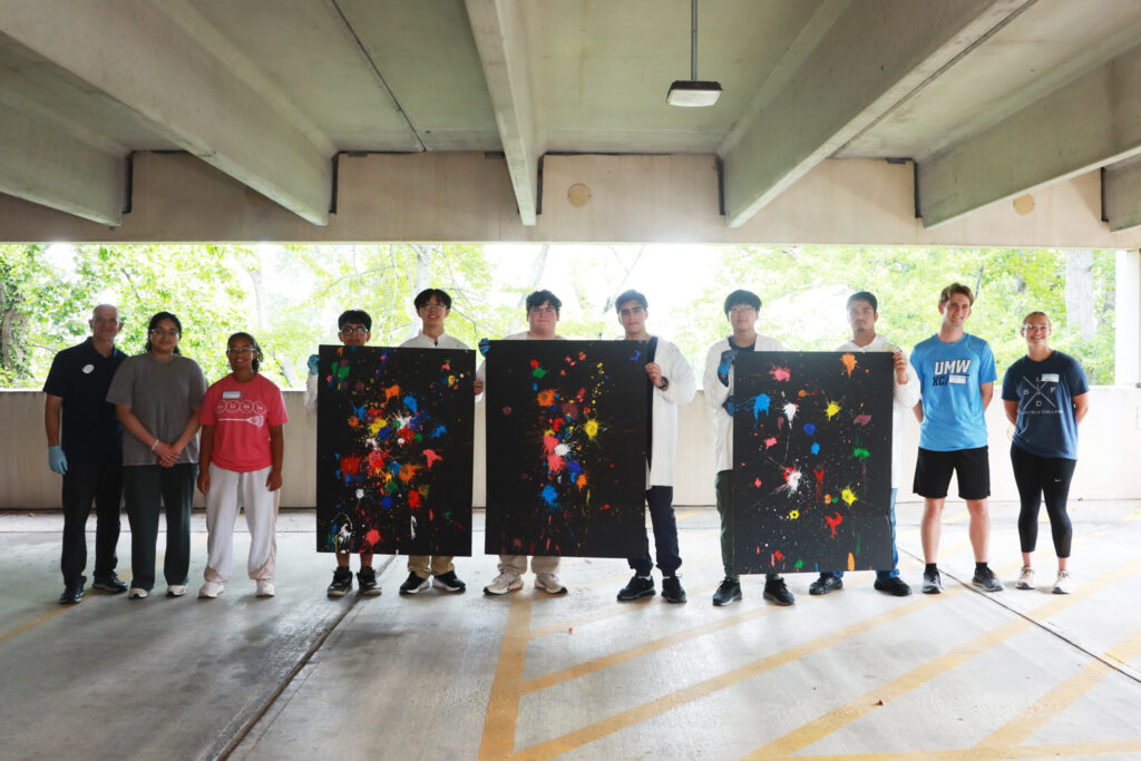 Participants in the PING program show off their paintball splatters, reminiscent of evolving stellar clusters. From left: UMW Physics Chair and Professor Matt Fleenor; UMW mentor Aliya Ather '28; volunteer mentor Emma Wallach, a Stafford High School junior who participated in the PING program at MSU; high schoolers Alexander Rosas, Vincent Phan, Tristan Towle, Zubair Mohammadzai, Michael Young, and Maiwand Barakzai; and UMW mentors CJ Hulleman '28 and Hannah Steele '26. Photo by K Pearlman Photography.