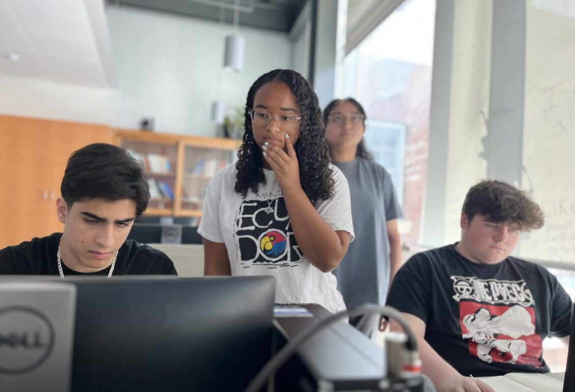High schoolers Zubair Mohammadzai (left) and Tristan Towle (right) are guided in a lesson by volunteer mentor Emma Wallach, a Stafford High School sophomore who already participated in the PING program at Michigan State University, and UMW mentor Aliya Ather '28 (background). Photo by Katie VanHouten '26.