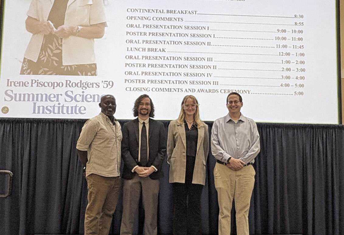 Eric Torres '26 (center left) and Lily Gruss '27 (center right) pose with their faculty mentors, Professor of Geology and Environmental Science Ben Odhiambo Kisila (left) and Professor of Chemistry Davis Oldham (right). Torres and Gruss placed first and second in the oral presentation category at the Irene Piscopo Rodgers '59 Summer Science Institute symposium, which earned them funding through the John C. and Jerri Barden Perkins '61 College of Arts and Sciences Student Research Endowment. Photo courtesy of Betsy Lewis/College of Arts and Sciences.