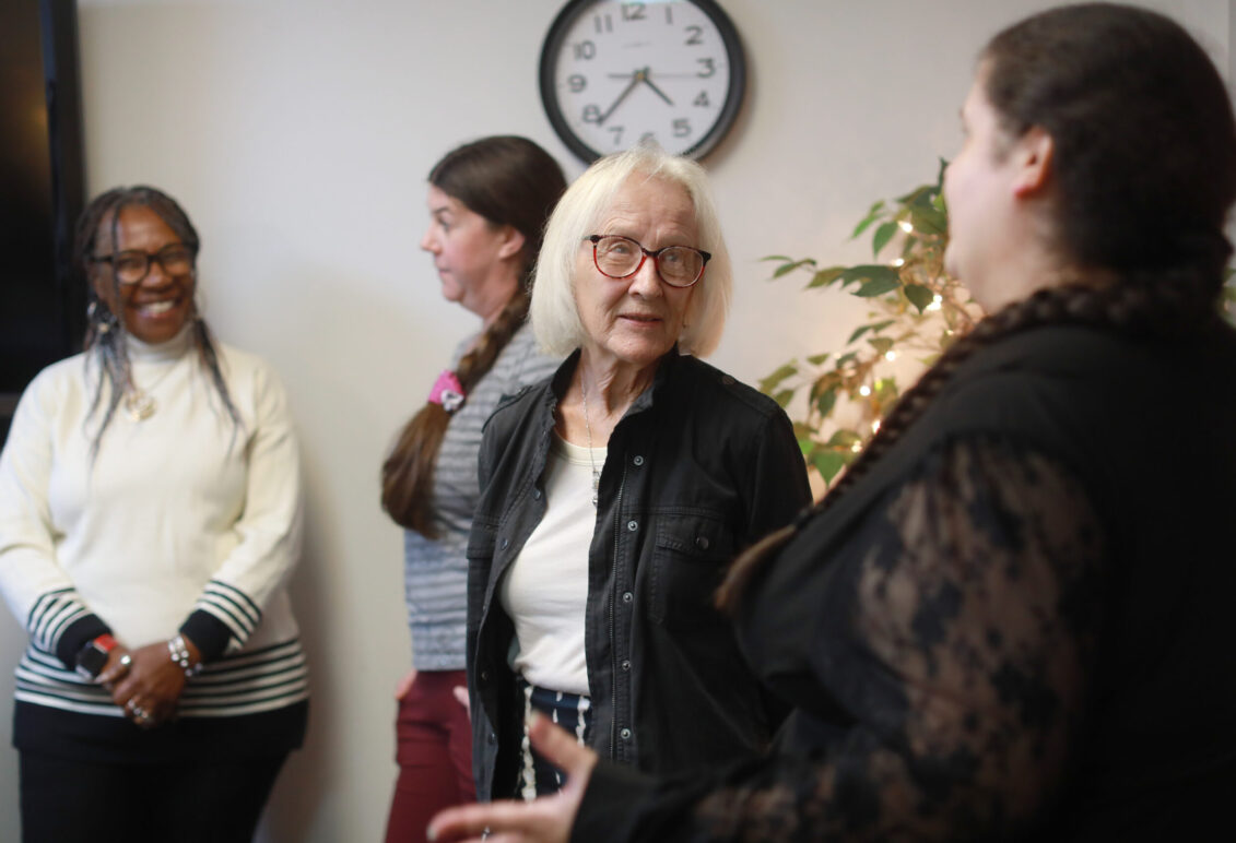 Foreground: Betty Talley (left) chats with Melissa Palguta, a staff counselor in the Talley Center. Background: Glorya Askew (left), a licensed clinical social worker and trainee, and Krysta Thomas, a staff counselor, converse. Photo by K Pearlman Photography.