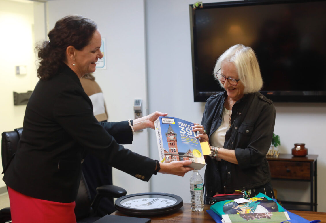 Dr. Juliette Landphair (left), associate vice president for health and well-being at Mary Washington, shows Betty Talley a copy of Princeton Review's 'The Best 391 Colleges' guide for 2026, which lists Mary Washington at #15 Best Student Support and Counseling Services. Photo by K Pearlman Photography.