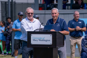 Coach Roy Gordon (right) poses for a photo with Assistant Athletic Director of Communications Clint Often during a ceremony held Sunday to name the Roy Gordon Field. Photo by Kaitlyn Kimball.