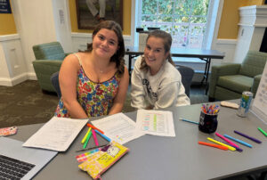 UMW first-year student Lucy Rabung (left) sought the help of her peer mentor, Lauren Spagnuolo, a sophomore, who helped her organize all her syllabi and record the dates of her assignments in a new day planner provided by LaunchPad.